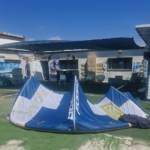 קייט משומש Ocean Rodeo Roam A-Series 9m בצבע כחול-לבן מונח על דשא